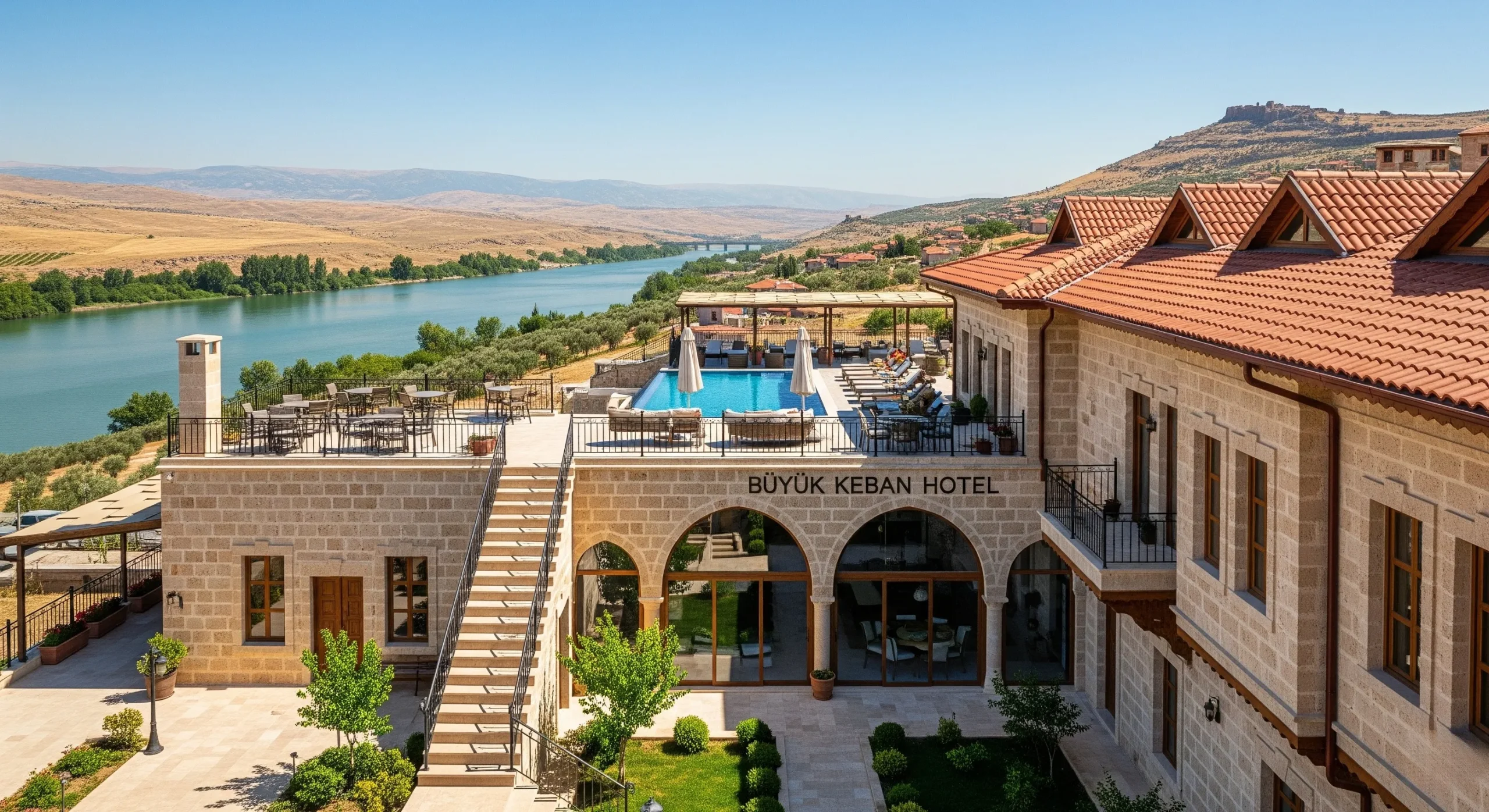 Elegant Büyük Keban Hotel overlooking the Euphrates River in Turkey's Keban region, showcasing traditional Ottoman architecture with modern amenities against the backdrop of Anatolian landscapes